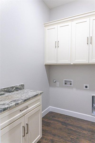 Laundry area featuring dark wood-type flooring, washer hookup, electric dryer hookup, and cabinet space Laundry area featuring dark wood-type flooring, washer hookup, electric dryer hookup, and cabinet space