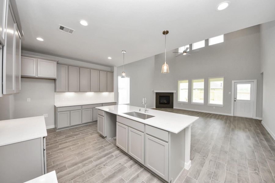 All of this overlooks your expansive family room, creating a perfect space for culinary delights and family gatherings. Sample photo of completed home with similar floor plan. Actual colors and selections may vary. All of this overlooks your expansive family room, creating a perfect space for culinary delights and family gatherings. Sample photo of completed home with similar floor plan. Actual colors and selections may vary.