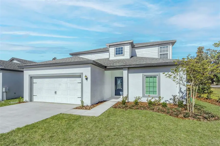 Front exterior of a new home in Tula Parc, Astatula, FL, highlighting curb appeal (Image 1). Front exterior of a new home in Tula Parc, Astatula, FL, highlighting curb appeal (Image 1).