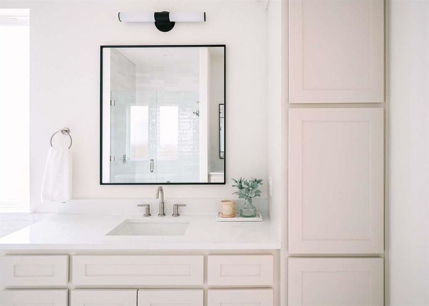 Bathroom with vanity and a shower with shower door