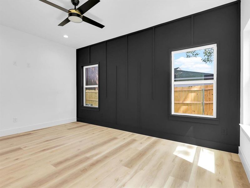 Spare room featuring light hardwood / wood-style flooring, a wealth of natural light, and ceiling fan