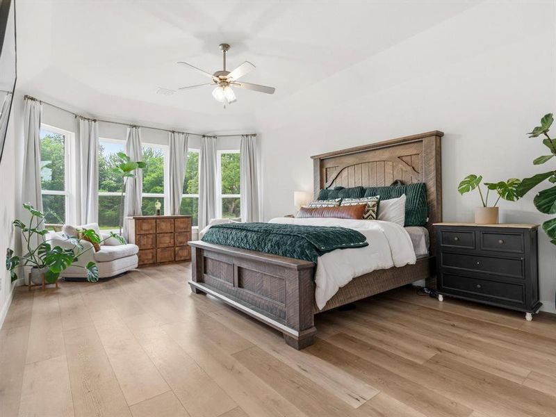 Private primary suite with spacious layout and peaceful views of the surrounding property.