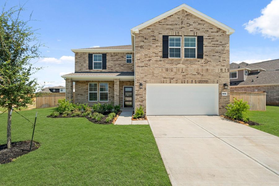 Front exterior of a new home in Sunterra, Katy, TX, highlighting curb appeal (Image 14).