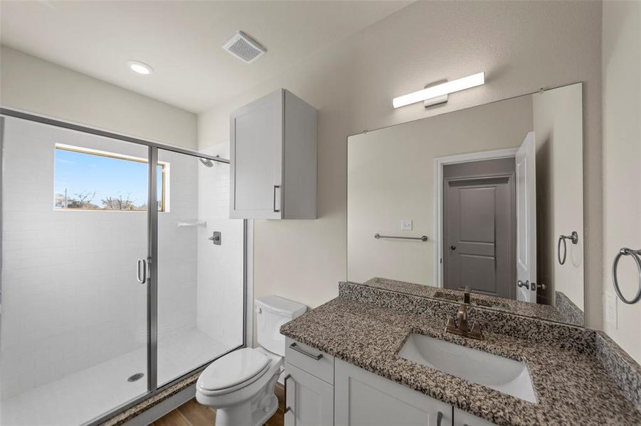 Bathroom featuring vanity and a shower stall