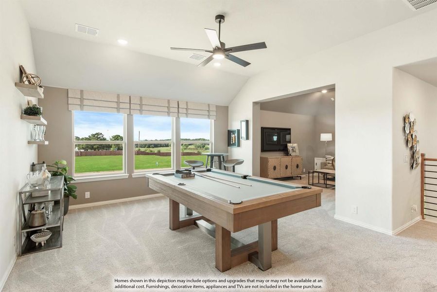 Game room with pool table, vaulted ceiling, ceiling fan, and large windows overlooking backyard
