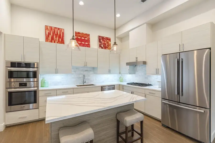 Sleek European Cabinetry. Soft Close and Undermount Lighting. Bosch Appliances - 5 Burner Gas Cooktop. (Picture was virtually staged with fridge) Sleek European Cabinetry. Soft Close and Undermount Lighting. Bosch Appliances - 5 Burner Gas Cooktop. (Picture was virtually staged with fridge)