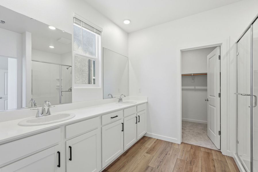 A bathroom with white cabinets. A bathroom with white cabinets.