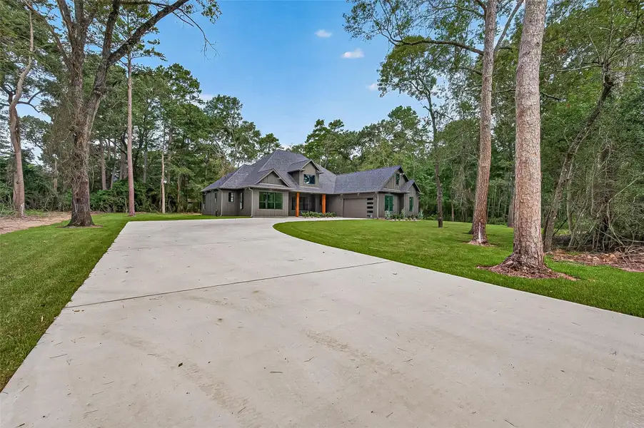 Front exterior of a new home in , Plantersville, TX, highlighting curb appeal (Image 23).