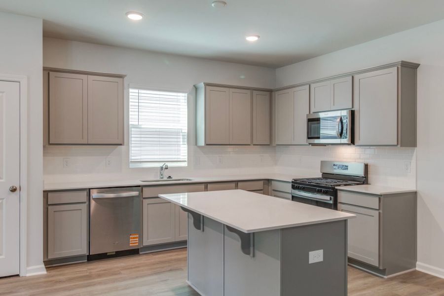 Discover the modern elegance in the kitchen with sleek grey cabinets.