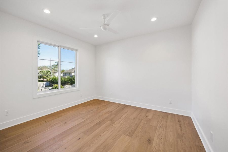 Light filled secondary bedroom features wide plank hardwood floors, recessed lighting, and a generously sized window overlooking the neighborhood. Clean lines and neutral finishes create a flexible space ready for guests, a nursery, or a dedicated home office.**PREVIOUS BUILDER WORK** Light filled secondary bedroom features wide plank hardwood floors, recessed lighting, and a generously sized window overlooking the neighborhood. Clean lines and neutral finishes create a flexible space ready for guests, a nursery, or a dedicated home office.**PREVIOUS BUILDER WORK**