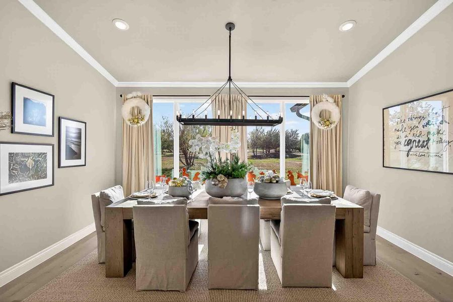Dining room featuring crown molding, recessed lighting, a chandelier, and wood finished floors