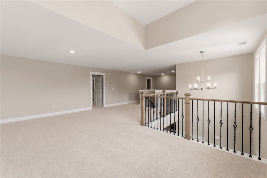 A spacious upper-level bonus room features plush c