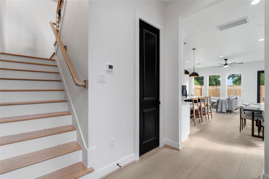 Bright entryway with open sightlines, wood stairs, and clean architectural lines. Bright entryway with open sightlines, wood stairs, and clean architectural lines.