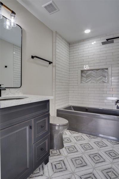 Bathroom with visible vents, toilet, and vanity