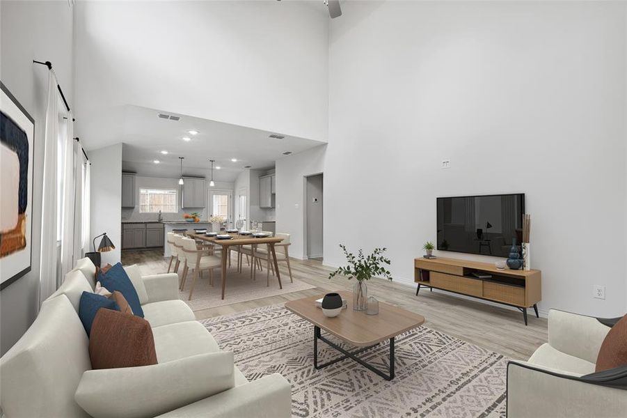 Living area with light wood-style floors and a high ceiling Living area with light wood-style floors and a high ceiling