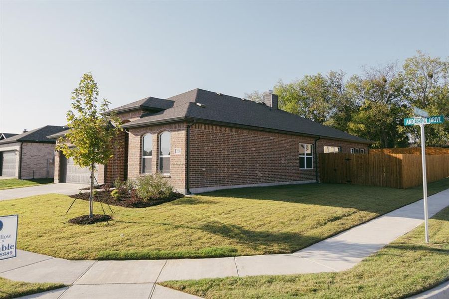 View of home's exterior featuring a yard and a garage