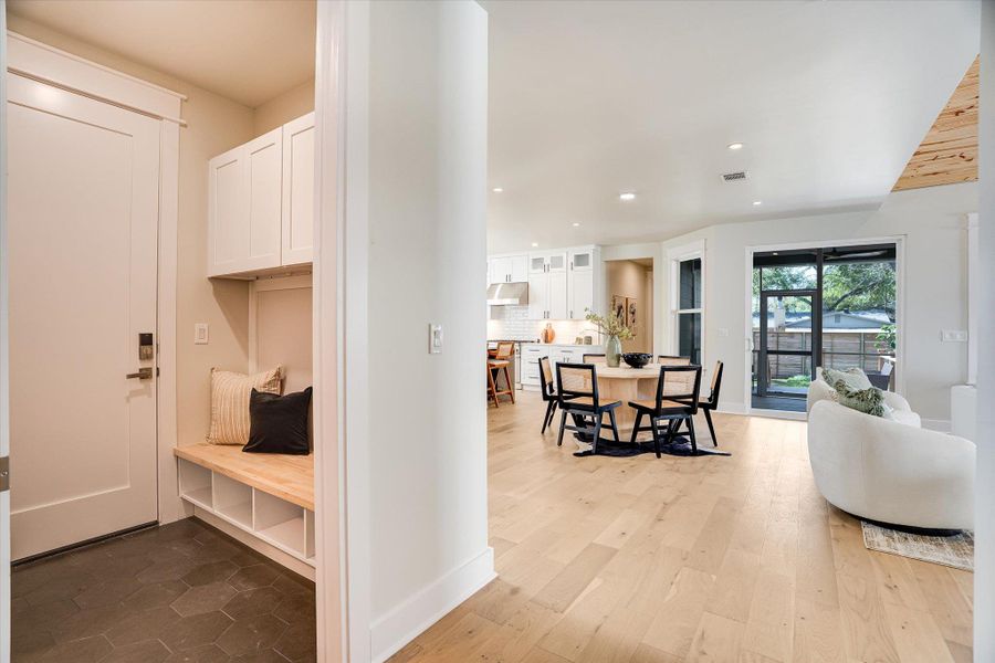 The property features an open concept living area with light wood flooring and recessed lighting The property features an open concept living area with light wood flooring and recessed lighting