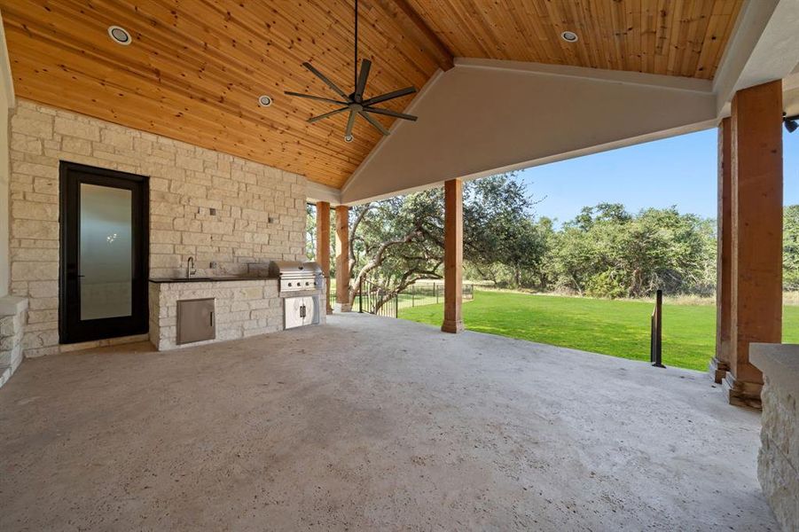 Built in grill and sink. Gorgeous view from the patio. On the left is a bathroom with an outdoor shower.