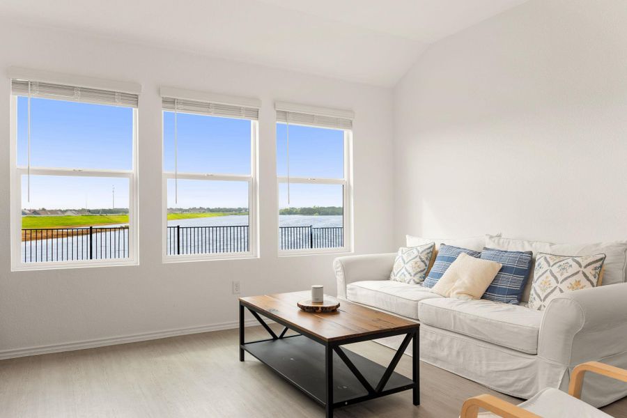 A generous living area offers serene water views and abundant natural light.