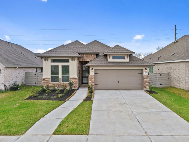 Front exterior of a new home in Pomona, Manvel, TX, highlighting curb appeal (Image 20).