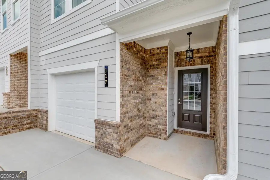 Exterior details and patio area of a home in Chimney Oaks Townhomes, Homer (Image 2). Exterior details and patio area of a home in Chimney Oaks Townhomes, Homer (Image 2).