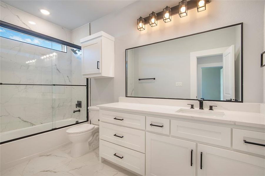 Bathroom featuring bath / shower combo with glass door, vanity, light marble finish flooring, and recessed lighting Bathroom featuring bath / shower combo with glass door, vanity, light marble finish flooring, and recessed lighting