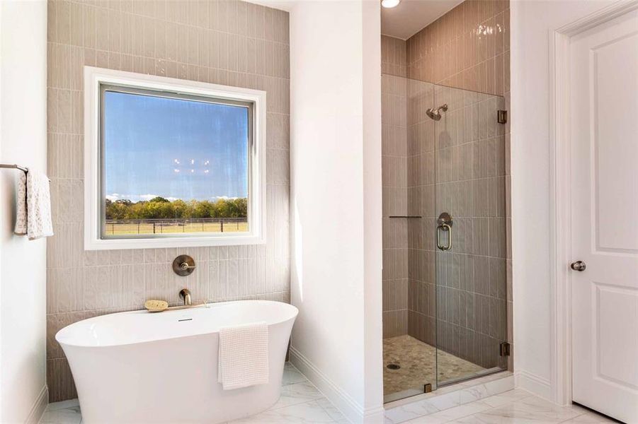 Bathroom with a soaking tub, marble finish floors, a shower stall, tile walls, and recessed lighting Bathroom with a soaking tub, marble finish floors, a shower stall, tile walls, and recessed lighting
