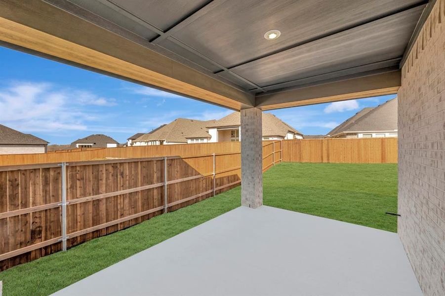 Fenced backyard featuring a patio