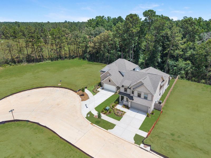 Additional aerial view of your new home surrounded by nature.