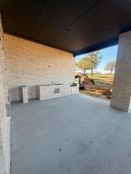 Brick covered patio to come complete with a gas grill, outdoor kitchen space, and refrigerator