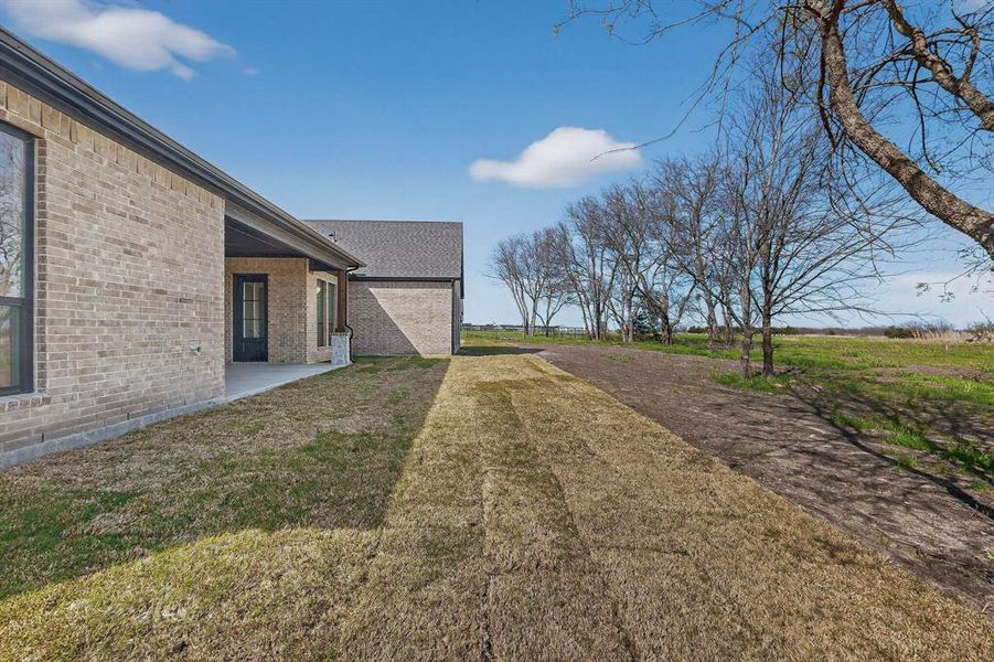 View of grassy yard with a patio