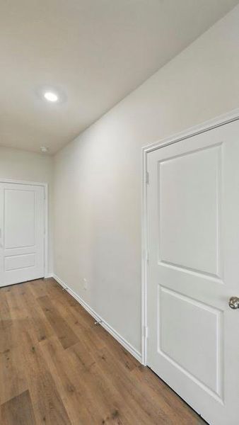 Empty room featuring dark wood-style floors and recessed lighting