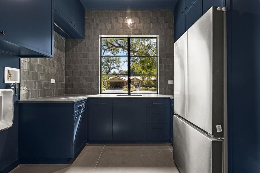 Laundry room is located on the main floor and includes a second fridge and tons of storage.