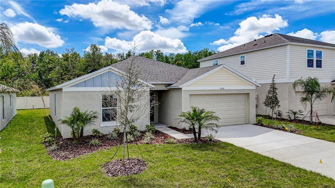 Front exterior of a new home in Crosswind Point, Parrish, FL, highlighting curb appeal (Image 17).