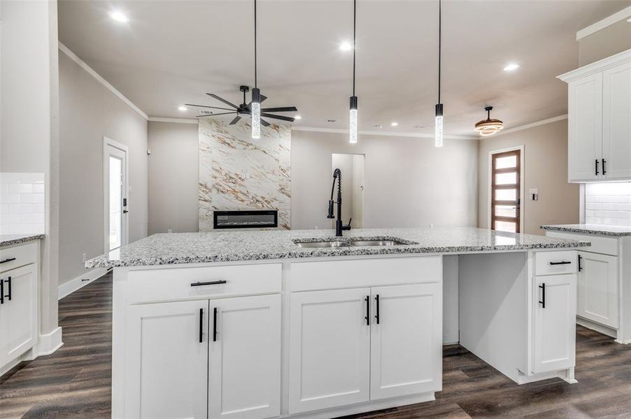 Kitchen featuring crown molding, ceiling fan, recessed lighting, dark wood-style flooring, and white cabinets