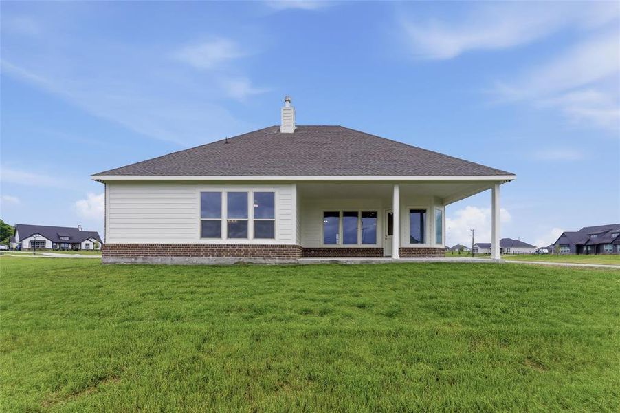 The property features a spacious yard with a lush green lawn