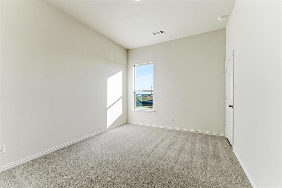 Unfurnished room featuring light colored carpet and baseboards