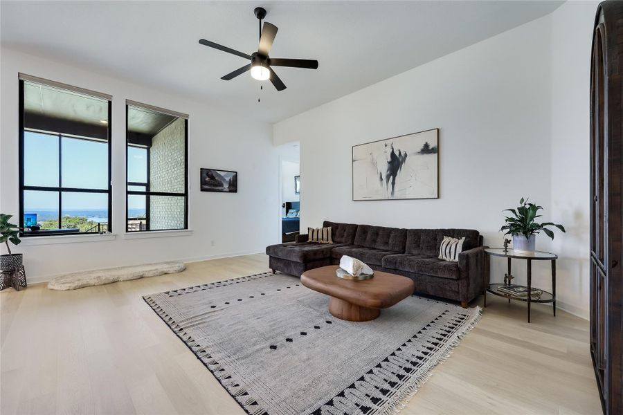 Sunlight streams through large windows onto beautiful hardwood floors in this open living area. Sunlight streams through large windows onto beautiful hardwood floors in this open living area.