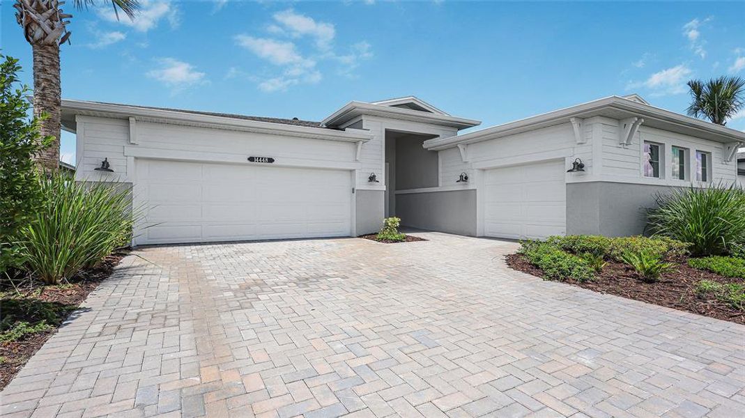 Front exterior of a new home in Woodland Preserve, Parrish, FL, highlighting curb appeal (Image 26).