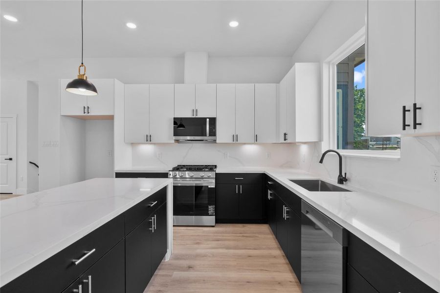 kitchen blending two-tone cabinetry, expansive prep space and tons of natural light streaming in from the kitchen window kitchen blending two-tone cabinetry, expansive prep space and tons of natural light streaming in from the kitchen window