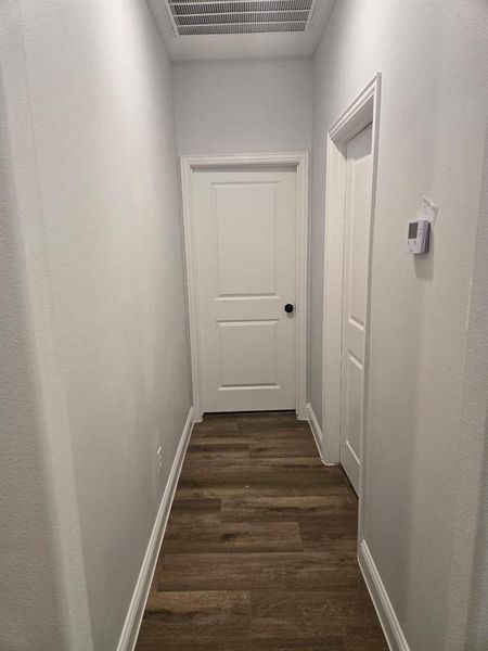 Corridor featuring dark hardwood / wood-style flooring