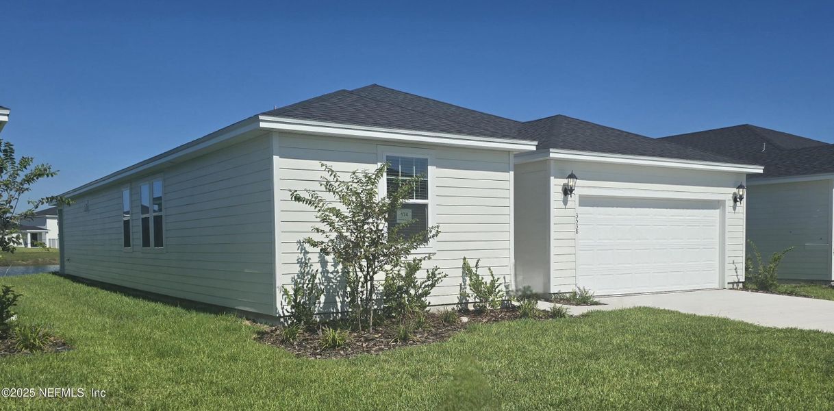 Front exterior of a new home in Lakes at Bella Lago - Signature Series, Green Cove Springs, FL, highlighting curb appeal (Image 18).