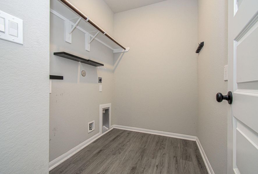In home laundry / utility room with shelving and clothing rod