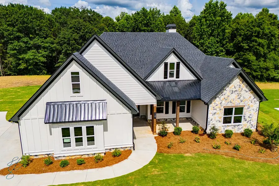 Front exterior of a new home in WOODMONT RESERVE, Roopville, GA, highlighting curb appeal (Image 38).