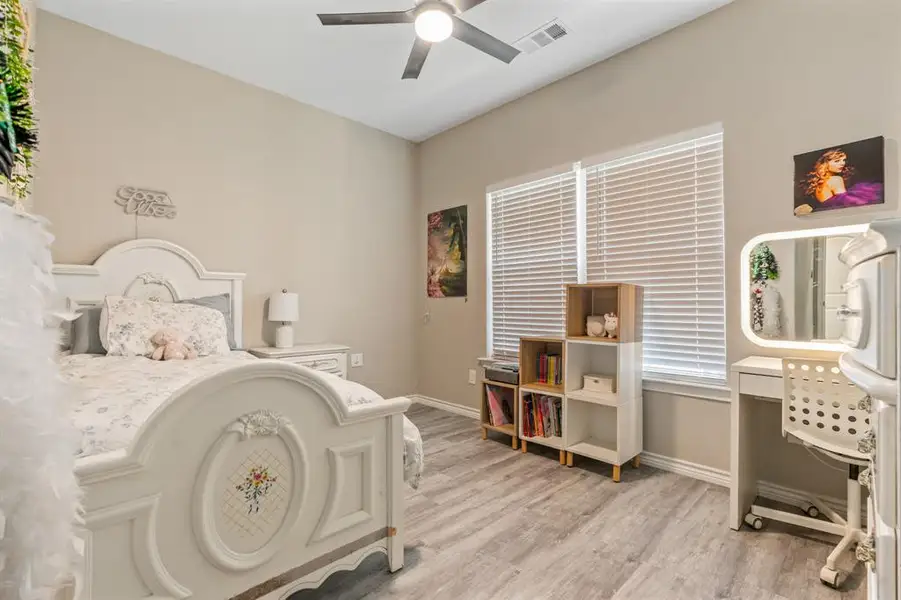 Downstairs Bedroom with light wood finished floors and ceiling fan Downstairs Bedroom with light wood finished floors and ceiling fan