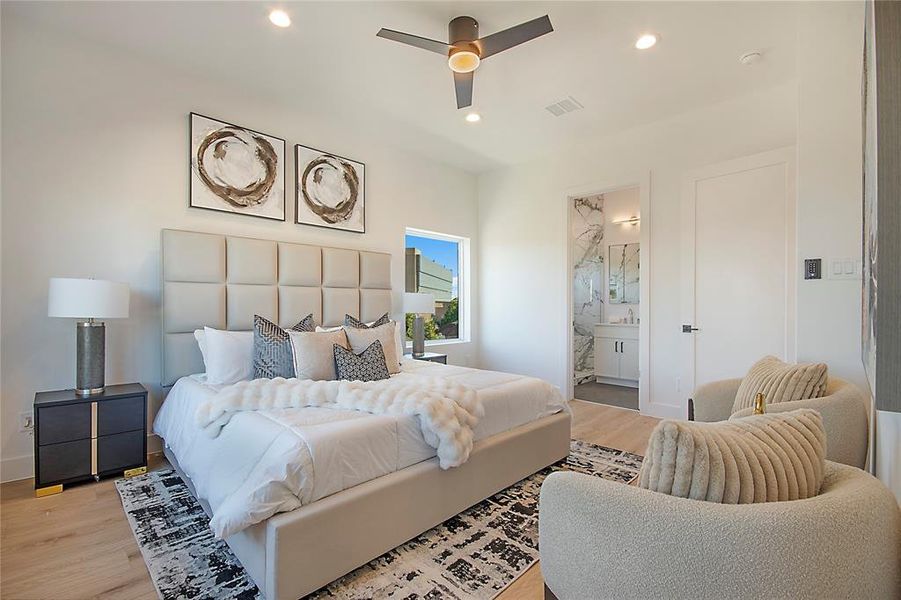 Bedroom with wood finished floors, recessed lighting, ensuite bathroom, and a ceiling fan Bedroom with wood finished floors, recessed lighting, ensuite bathroom, and a ceiling fan