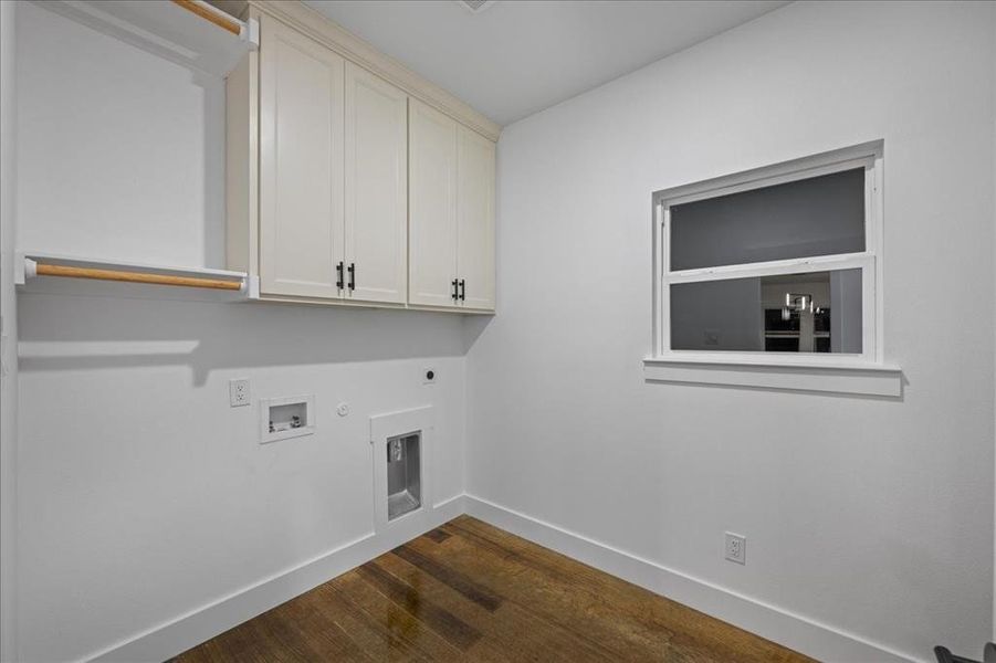 Laundry room featuring cabinet space, hookup for a washer and an electric dryer