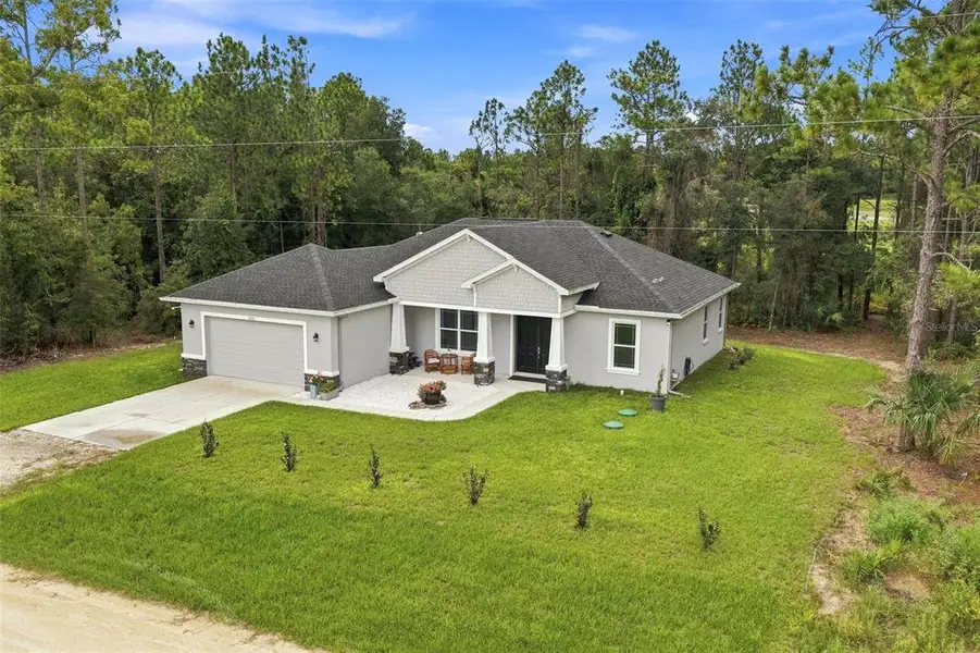 Front exterior of a new home in , Weeki Wachee, FL, highlighting curb appeal (Image 21). Front exterior of a new home in , Weeki Wachee, FL, highlighting curb appeal (Image 21).