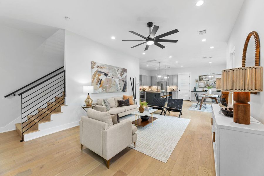 Living room with high ceilings, modern ceiling fan and recessed lighting. Living room with high ceilings, modern ceiling fan and recessed lighting.