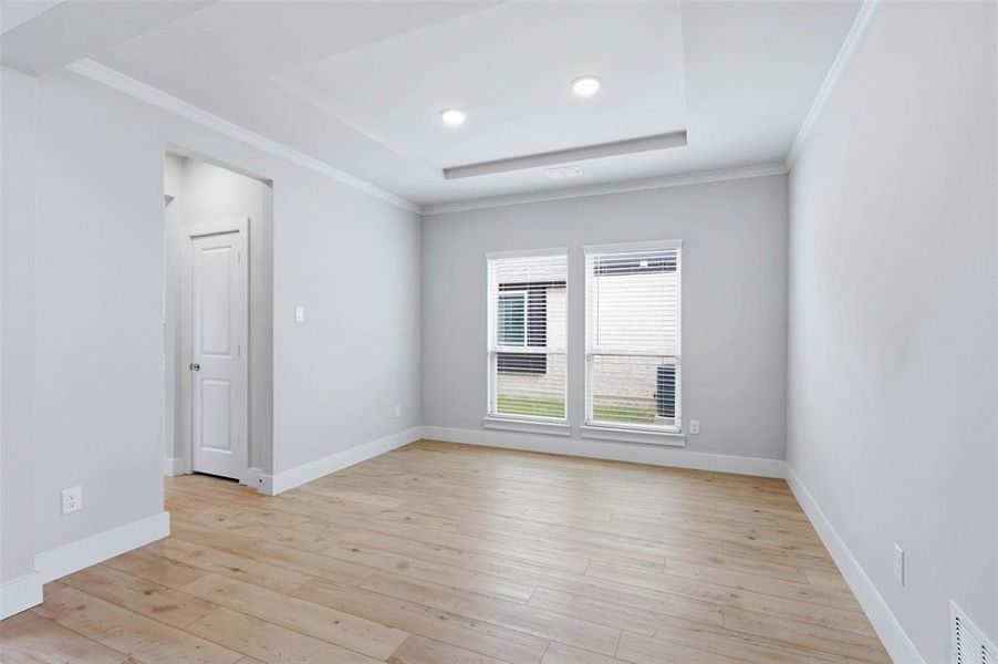 Formal dining room with large windows, neutral finishes, and flexible space for gatherings or everyday use.